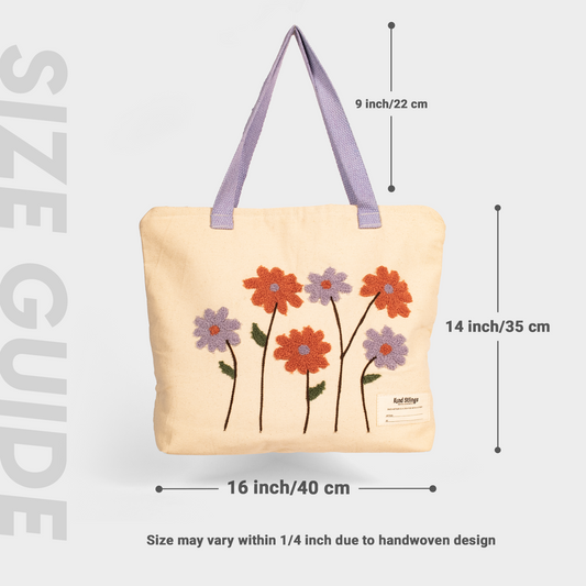 Whie tote bag with floral designs and measurements on a light gray background