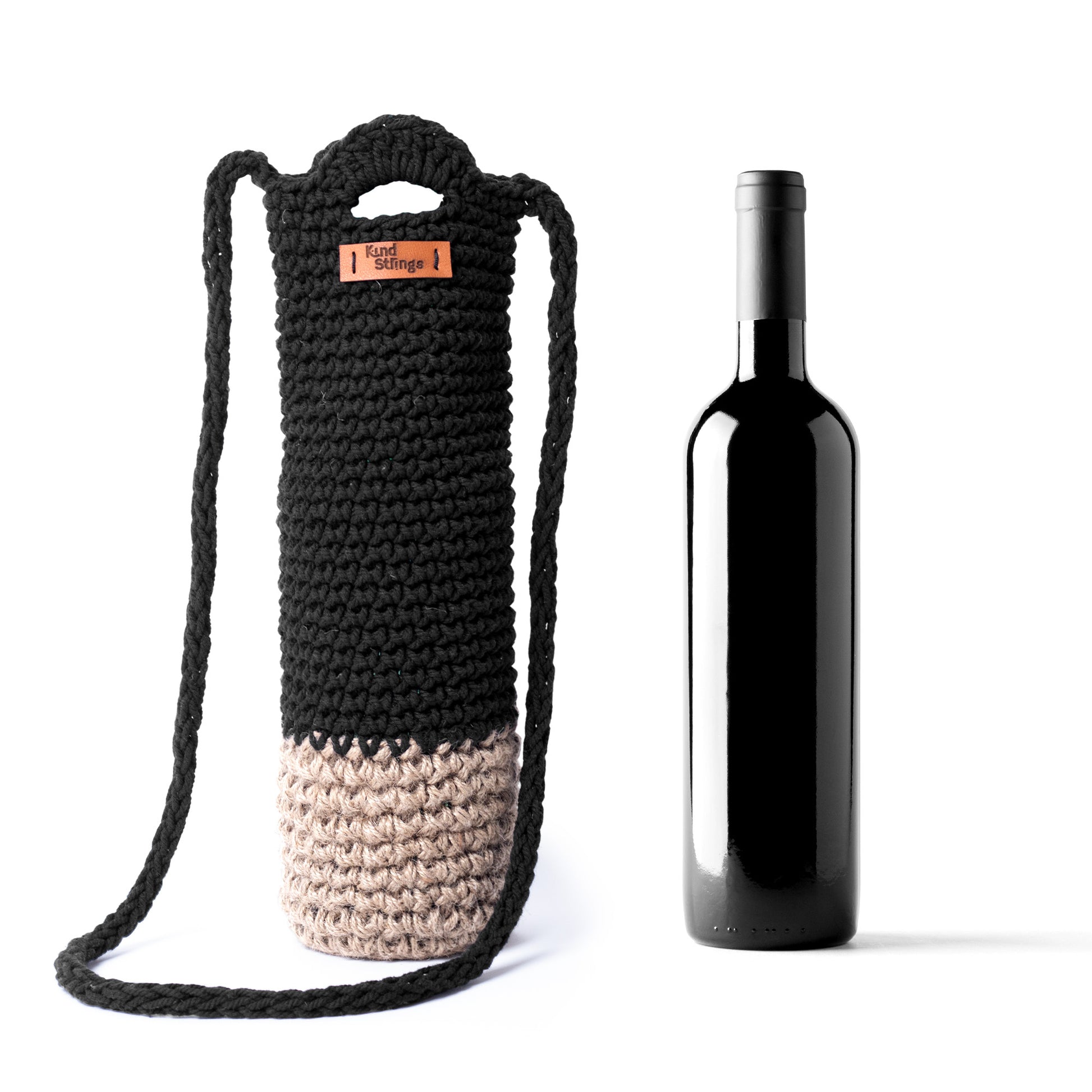 Black and beige crocheted wine bottle holder with a bottle on a white background