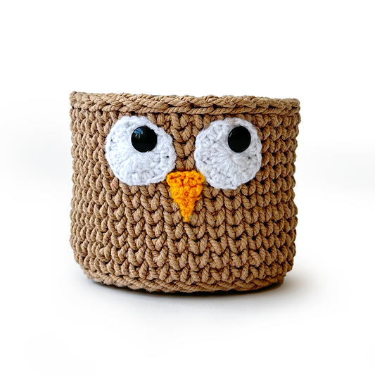 Crocheted owl-shaped basket with a white background