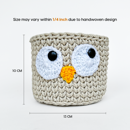 Crocheted owl-shaped basket with measurements on a white background