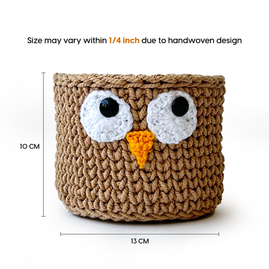 Crocheted owl-shaped basket with measurements on a white background