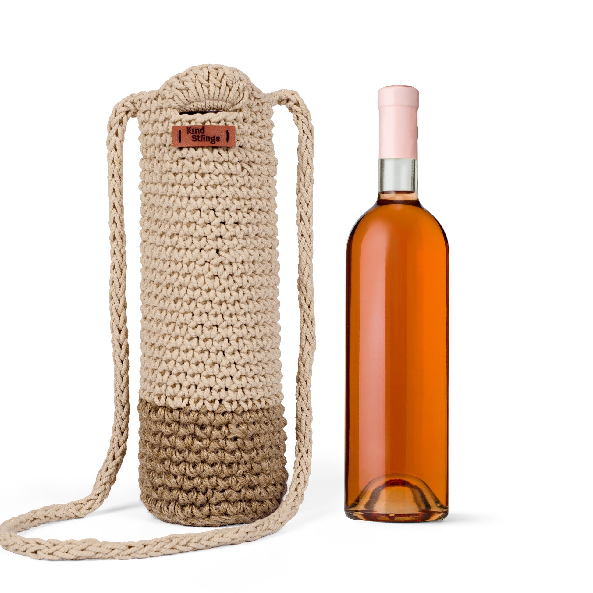 Knitted beige  bottle holder with a pink  bottle on a white background