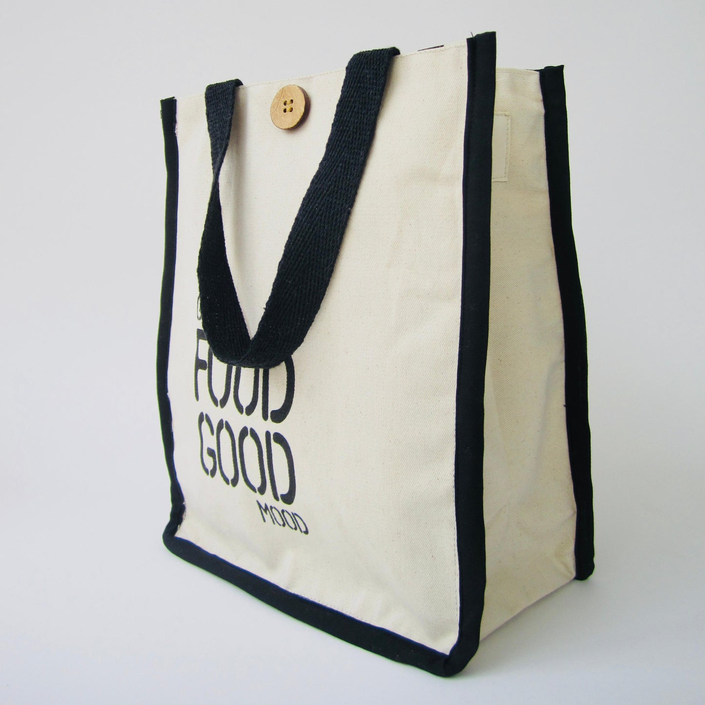 White tote bag with black text and handles on a white background