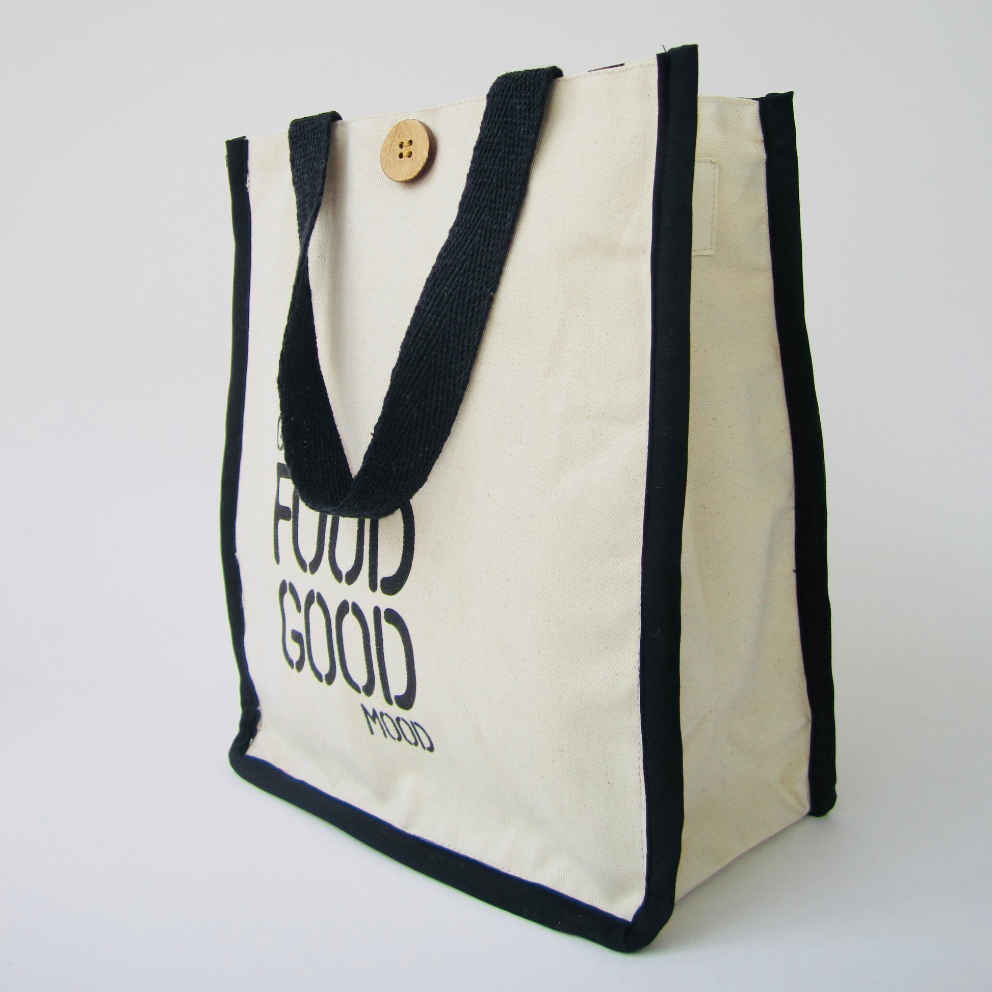 White tote bag with black text and handles on a white background