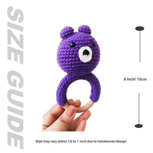 Purple crocheted bear ring held in a hand with size guide text and measurement.