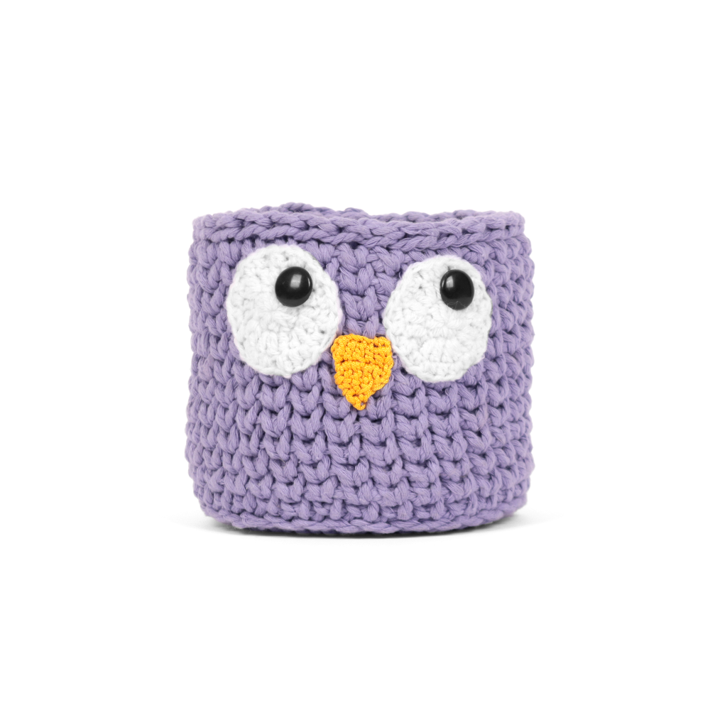 Purple crocheted owl-shaped container on a white background