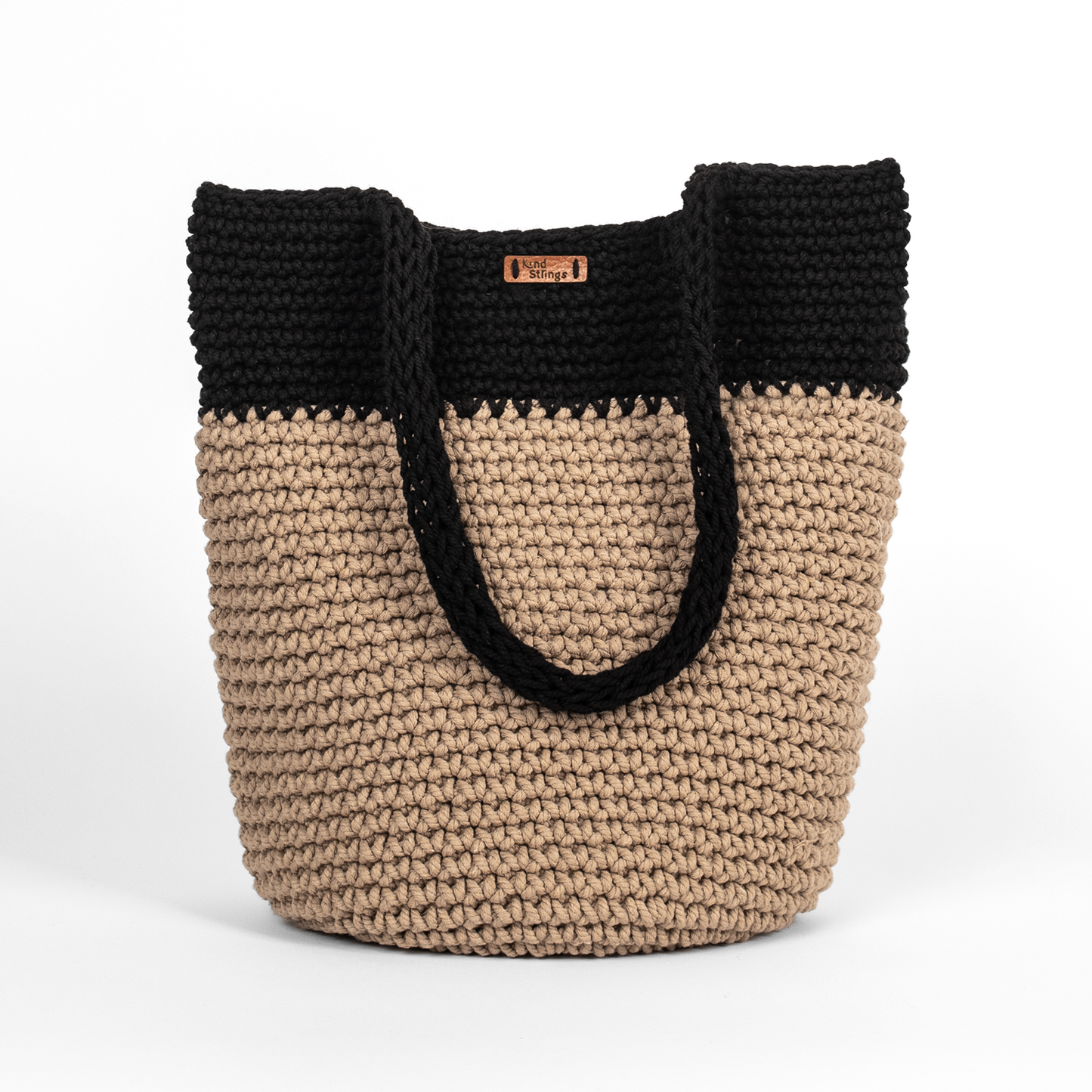 Two-toned black and beige woven bag on a white background
