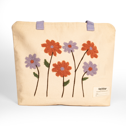 White tote bag with embroidered flowers on a white background