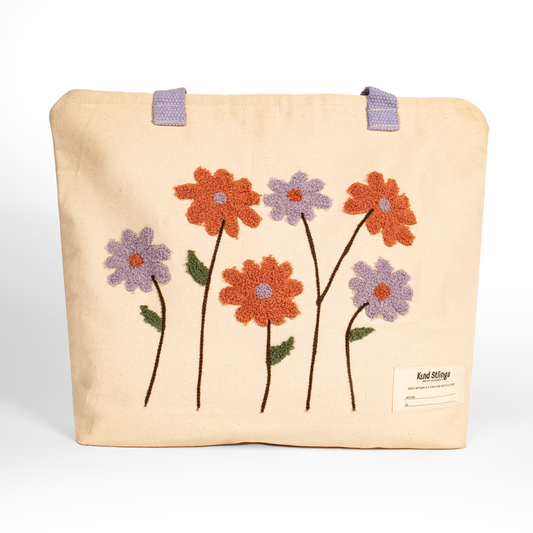 White tote bag with embroidered flowers on a white background