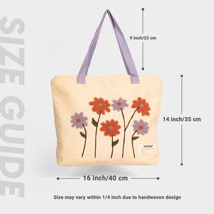 Whie tote bag with floral designs and measurements on a light gray background
