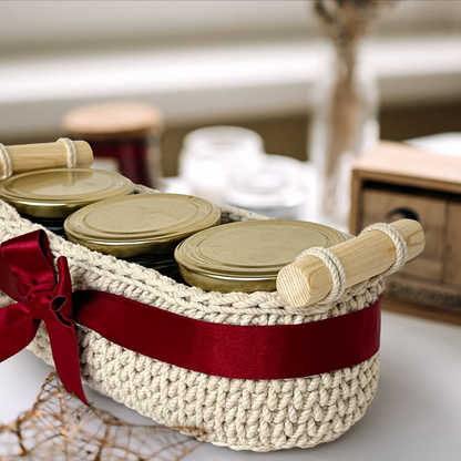 Woven basket with jars and a red ribbon on a blurred background