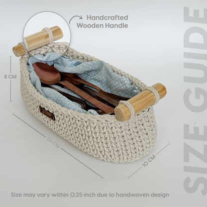 Woven basket with wooden handle containing cutlery and a cloth, with measurements and text on a light gray background.