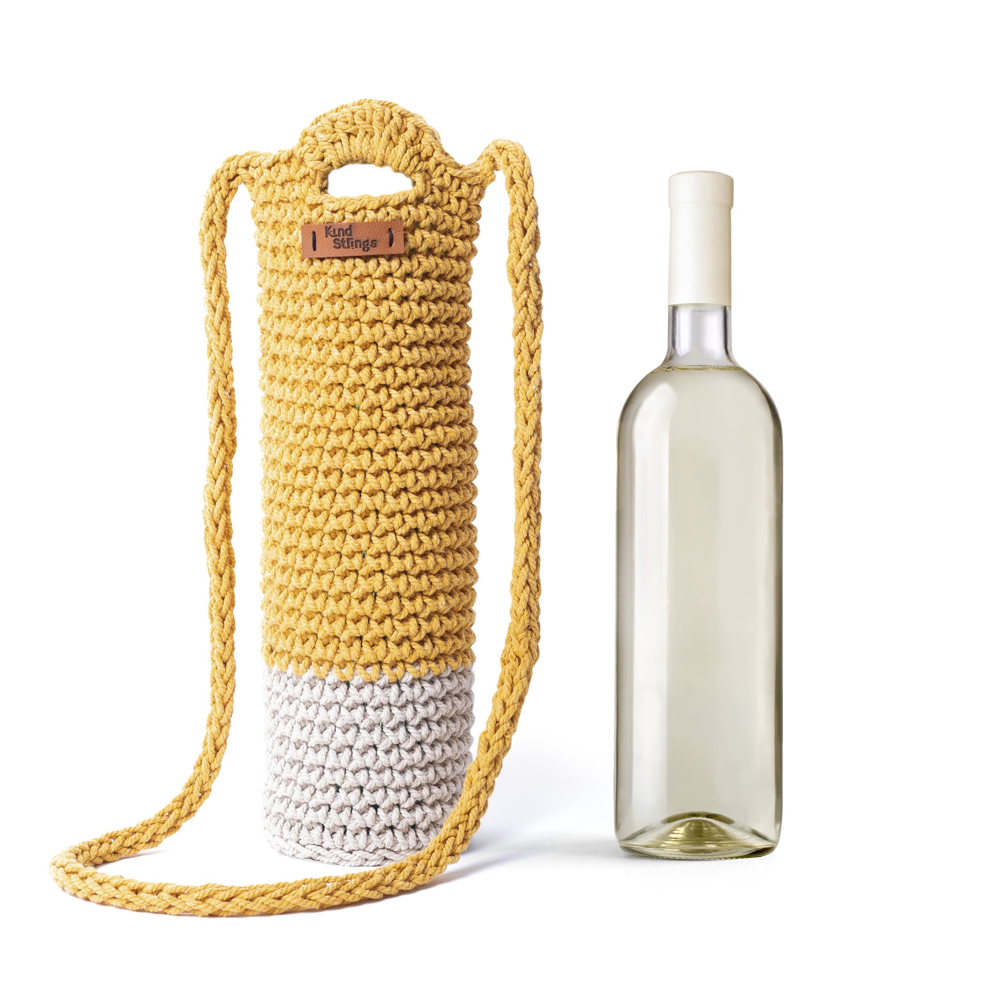 Yellow and white crocheted bottle holder with a bottle on a white background
